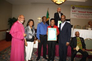 Bishop Gregory, Chancillor McCalla, Mr. V. Murray, son of Honoree Mrs. Laceta Maorlese Brown receives Citation from Dr. Earl Jarrett of JN for 50 years of service to the Anglican Church in Ja.