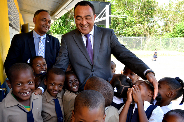 Christopher Tufton interacts with students of the Brown’s Hall Primary School handing over expansion project