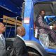 Desmond McKenzie, tries out the controls of one of the six new garbage trucks acquired for three of the NSWMA reginal offices