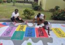 Volunteers paint encouraging and colorful messages on school grounds in Saint Lucia