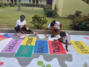 Volunteers paint encouraging and colorful messages on school grounds in Saint Lucia